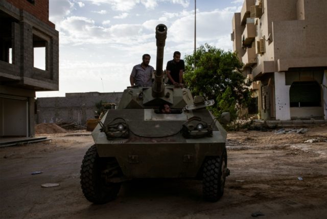 Misrata's fighters are pictured on a tank during clashes against Islamic State group in Si
