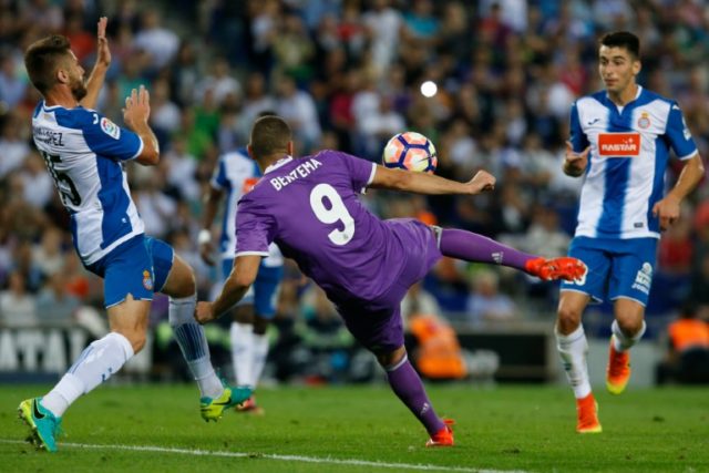 Real Madrid's forward Karim Benzema (C) kicks the ball during a Spanish league football ma