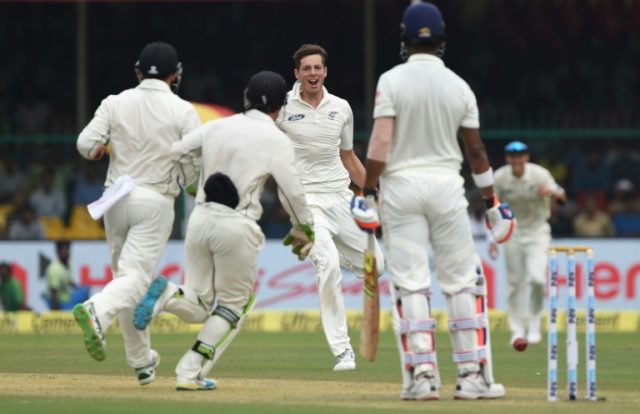New Zealand's Mitchell Santner (C) celebrates the wicket of India's Lokesh Rahul during th