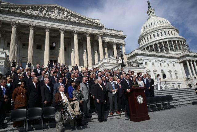Speaker of the House Paul Ryan and House Minority Leader Nancy Pelosi join members of the