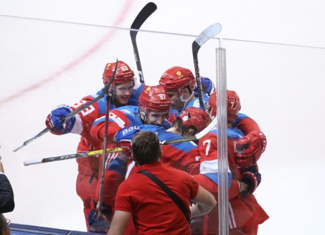 Ivan Telegin #77 of Team Russia is congratulated on his second period goal by teammates ag