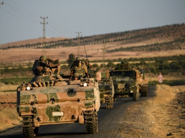 Turkish soldiers stand in a Turkish army tank driving back to Turkey from the Syrian-Turkish border town of Jarabulus on September 2, 2016 in the Turkish-Syrian border town of Karkamis