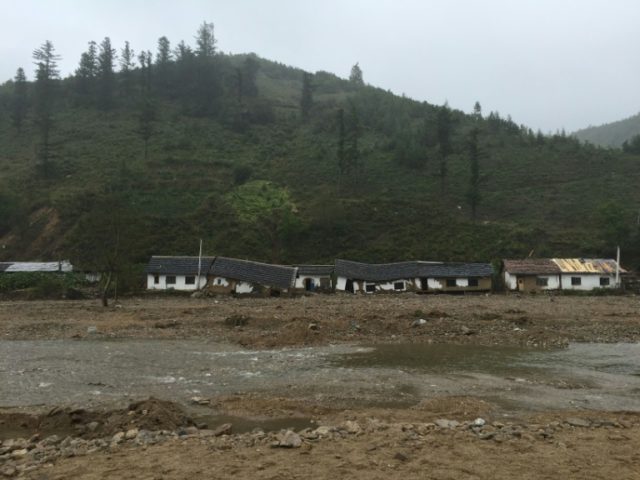 Damage to houses, caused by heavy flooding of the Tumen river along the road from Musan to