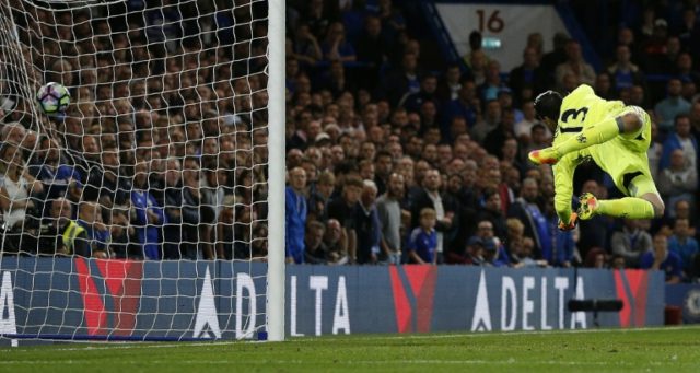 Chelsea's goalkeeper Thibaut Courtois jumps but fails to to save a long-range shot from Li