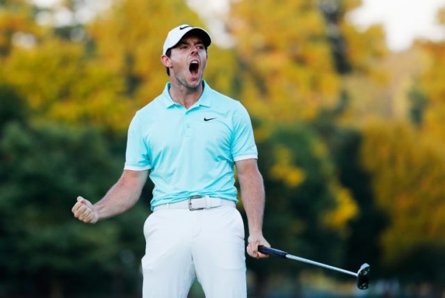 Rory McIlroy of Northern Ireland celebrates a birdie putt to defeat Ryan Moore on the four