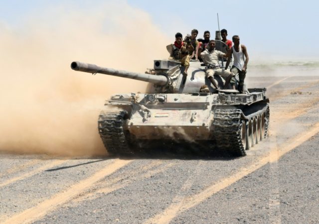 Fighters loyal to Yemeni President Abedrabbo Mansour Hadi drive a tank in the area of the