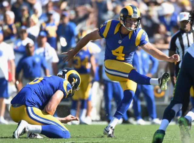 Greg Zuerlein of the Los Angeles Rams kicks a field goal out of a hold by teammate Johnny