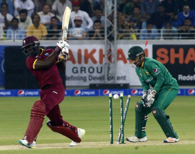 West Indies' Andre Fletcher (L) is bowled out by Pakistan's Imad Wasim (unseen) as wicket
