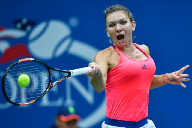 Simona Halep of Romania hits a return against Lucie Safarova of the Czech Republic during