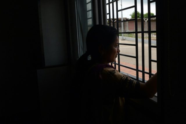 Indian surrogate mother Alka Shivankar, 32, looks out of a window of the Akanksha Hospital