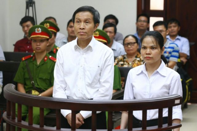 Nguyen Huu Vinh (C), was arrested in 2014 and accused of disseminating anti-government art