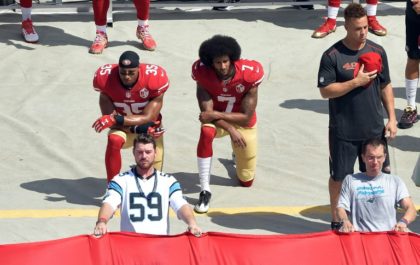 Colin Kaepernick #7 and Eric Reid #35 of the San Francisco 49ers kneel during the national