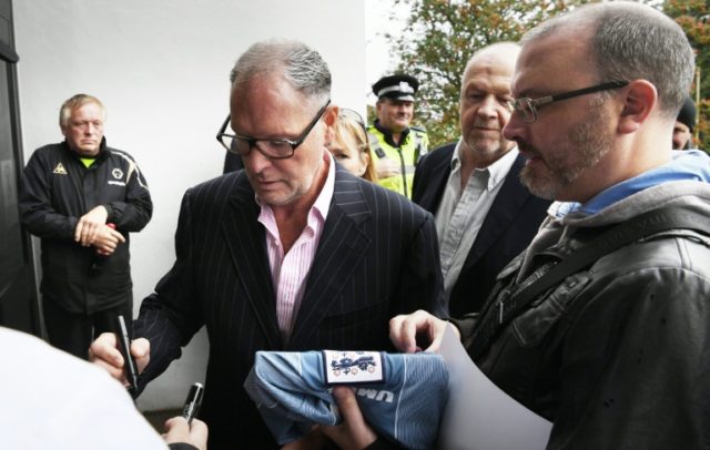 Former England footballer Paul Gascoigne (2L) signs autographs as he arrives at Dudley Mag