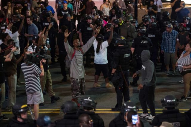 Protesters face riot police during a demonstration against police brutality in Charlotte,