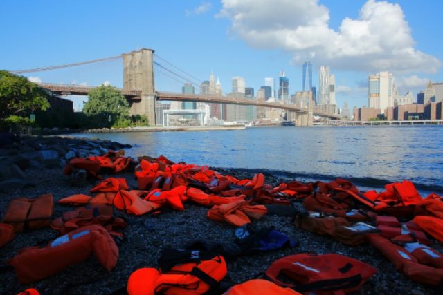 Life jackets collected from the beaches of Chios, Greece, are displayed at the Brooklyn Br