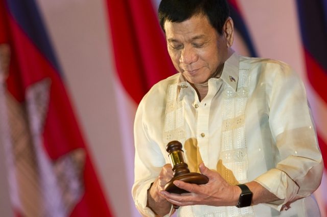 Philippine President Rodrigo Duterte holds the gavel during the closing ceremony of the As