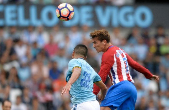 Atletico Madrid forward Antoine Griezmann (R) heads the ball to score in their La Liga mat