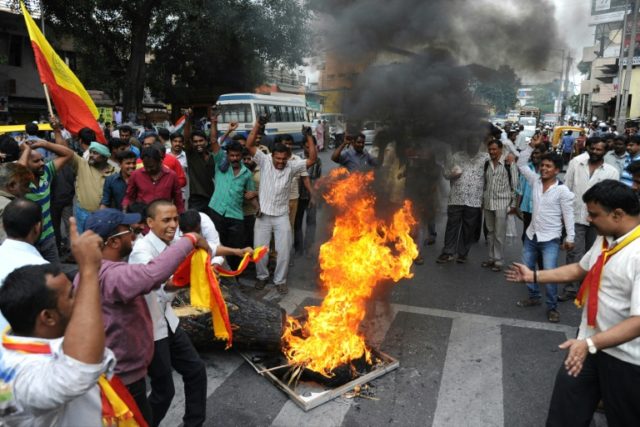 Protesters shout slogans and burn an effigy of Tamil Nadu chief minister J Jayalalithaa in