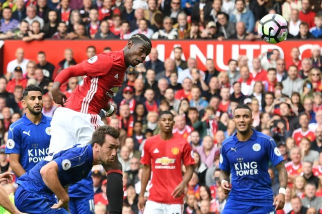 Manchester United's French midfielder Paul Pogba (2L) heads his side's fourth goal against