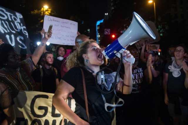 Hundreds marched to the city police station in Charlotte, North Carolina, carrying signs s