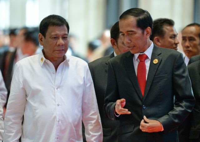Philippine President Rodrigo Duterte (left) listens to his Indonesian counterpart Joko Wid