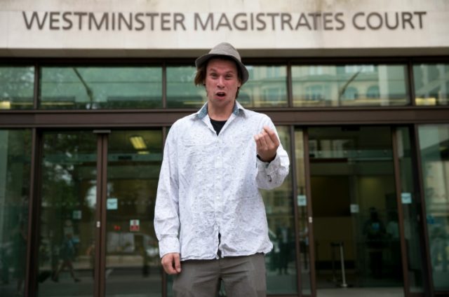 Lauri Love poses for photos outside Westminster Magistrates Court in central London on Jul