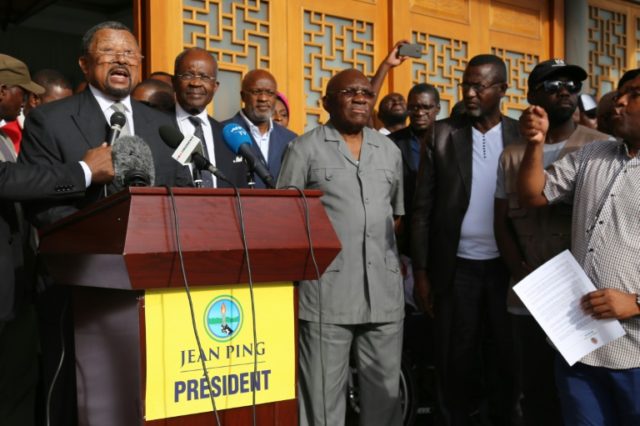 Gabonese opposition leader Jean Ping (L) flanked by opponents Casimir Oye Mba (2L) and Zac
