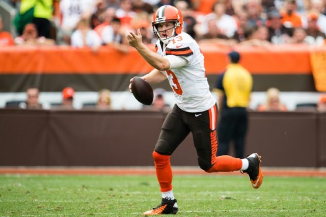 Quarterback Josh McCown #13 of the Cleveland Browns yells to his receiver as he runs out o
