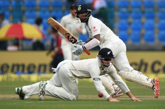 New Zealand's Tom Latham (left) makes an unsuccessful attempt to stop a shot by Indian bat