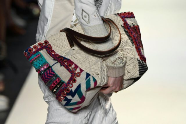 A model walks the runway, bag detail, at Jeans For Refugees By Johny Dar during New York F
