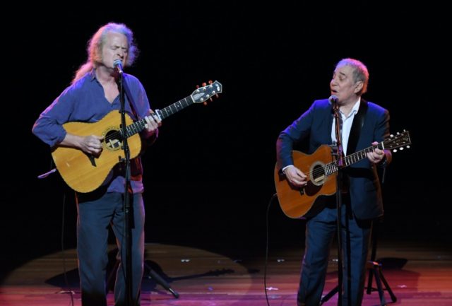 Paul Simon (R) performs onstage during Global Citizen: The World On Stage at NYU Skirball