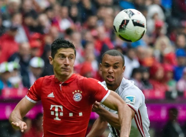 Bayern Munich striker Robert Lewandowski (front) in action against FC Ingolstadt in southe
