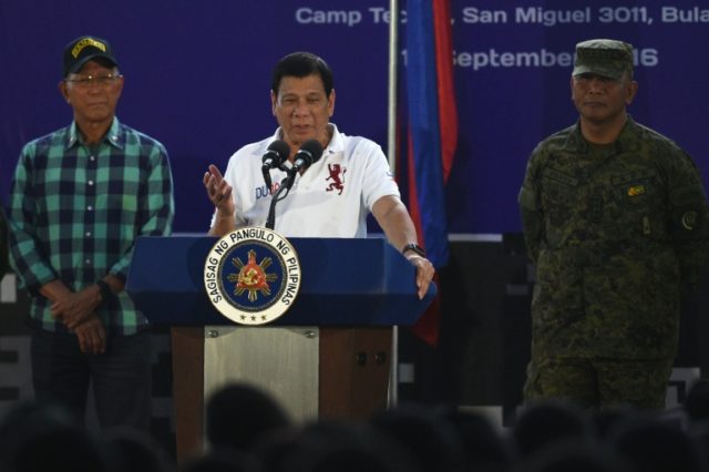 Philippine President Rodrigo Duterte (C) delivers a speech before members of the Scout Ran