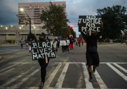 Protesters march during a demonstration against police brutality in Charlotte, North Carol