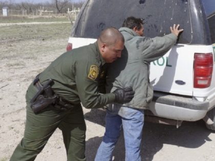 NBC NEWS -- Pictured: Border Patrol Agents arrest 8 suspected illegals and read them their Miranda Rights in Maverick County, near Eagle Pass, TX, as they try to ride a freight train into the United States on February 27, 2007 -- Photo by: Al Henkel/NBC NewsWire