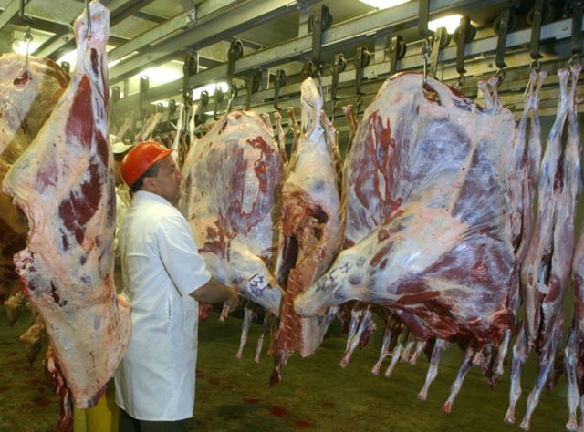 Abdul Aziz inspects halal beef and goat meat at his halal slaughter house, in Newark, N.J.