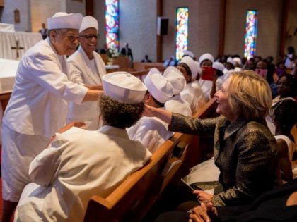 Democratic presidential candidate Hillary Clinton is greeted by members of the audience after speaking at the Little Rock AME Zion Church in Charlotte, N.C., Sunday, Oct. 2, 2016.