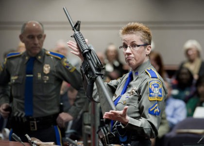 FILE - In this Jan. 28, 2013, file photo, firearms training unit Detective Barbara J. Mattson, of the Connecticut State Police, holds up a Bushmaster AR-15 rifle, the same make and model of gun used by Adam Lanza in the Sandy Hook School shooting, during a hearing of a legislative …