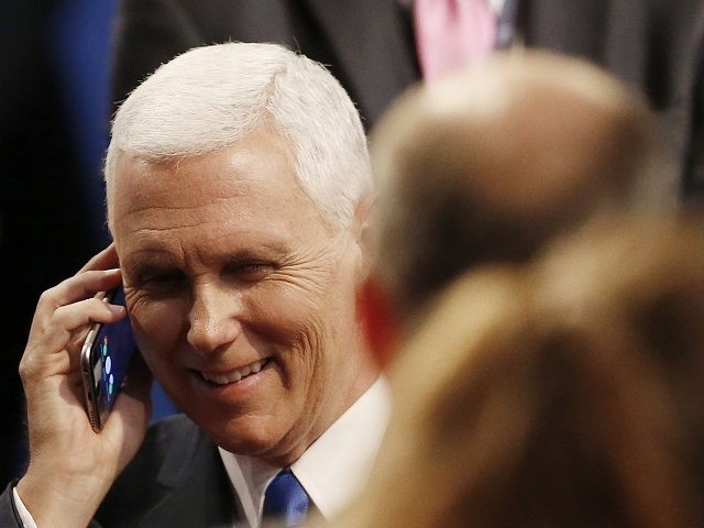 Republican vice-presidential nominee Gov. Mike Pence speaks on a phone after the vice-pres