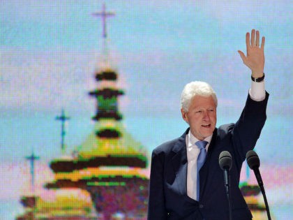 Former US President Bill Clinton greets people during an anti-AIDS action called "Fig