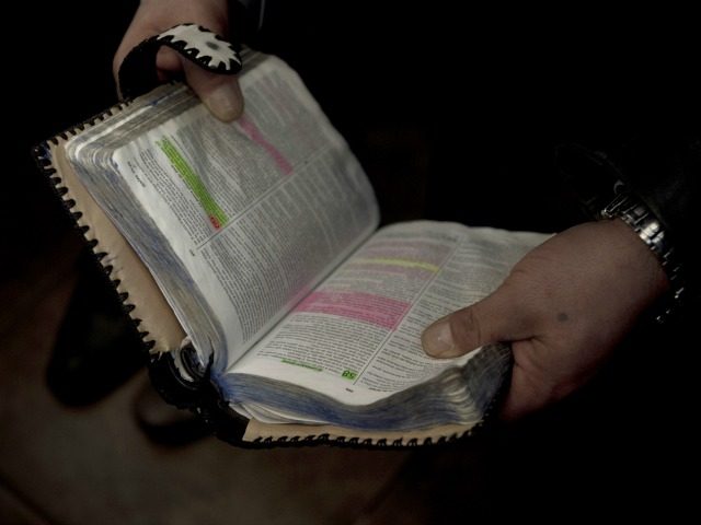 An evangelist inmate reads the Bible with their fellow prisoners in the Colina prison in Santiago, Chile, August 22, 2014.