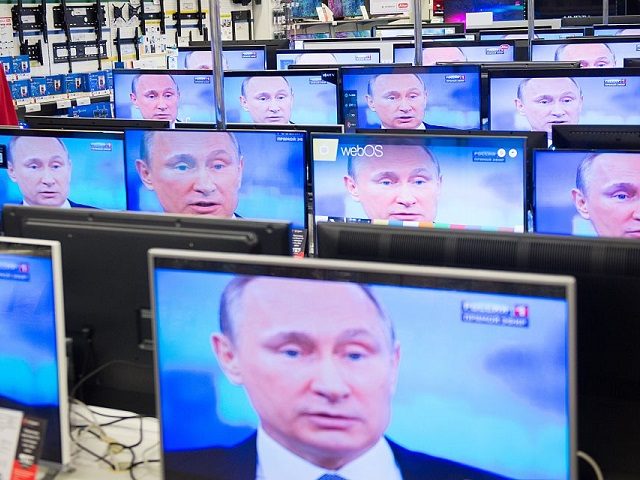An employee stands by TV sets in a shop in Moscow on April 16, 2015 during the broadcast of Russian President Vladimir Putin's annual televised phone-in with the nation. AFP PHOTO / ALEXANDER UTKIN (Photo credit should read ALEXANDER UTKIN/AFP/Getty Images)