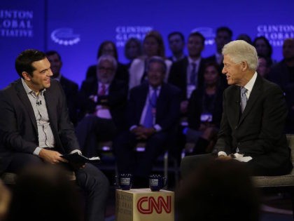 Prime Minister of Greece Alexis Tsipras (L) speaks with former President Bill Clinton duri