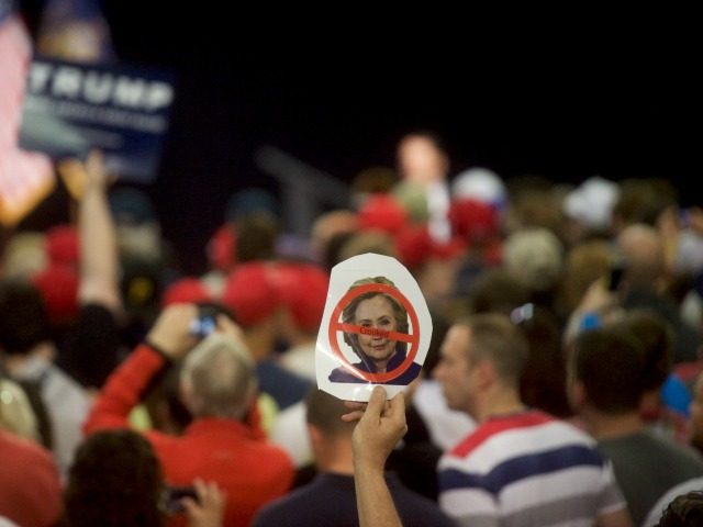A Donald Trump supporter holds a 'Crooked Hillary' sign during a rally at the Pe
