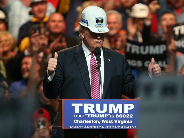 Republican Presidential candidate Donald Trump models a hard hat in support of the miners