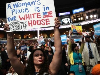 A delegate holds up a sign that reads 'A Woman's Place is in The White House&#03