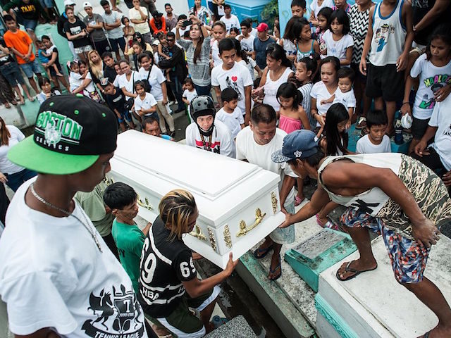 MANILA, PHILIPPINES - AUGUST 21: Relatives mourn as the coffin of an alleged thief and dr