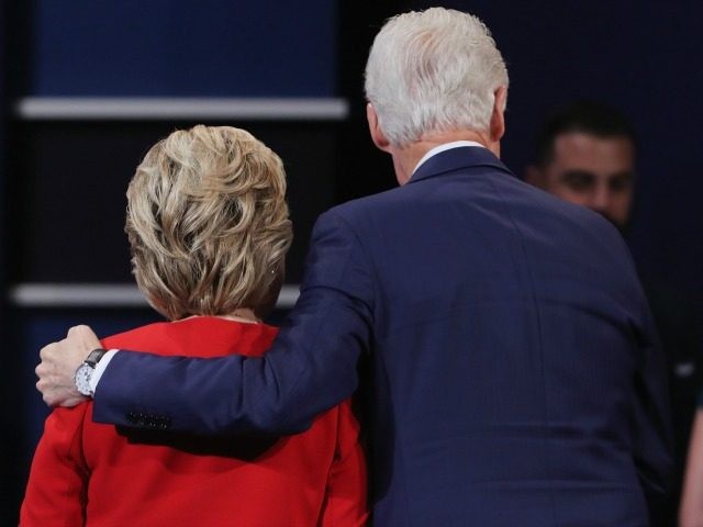 Hillary Clinton (L) hugs husband and former U.S. President Bill Clinton (R) September 26,