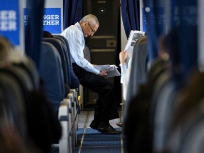 ohn Podesta, Clinton Campaign Chairman, reads over notes on board Democratic presidential nominee Hillary Clinton's plane at Westchester County Airport September 27, 2016 in White Plains, New York, before traveling with Clinton to Raleigh, North Carolina. / AFP / Brendan Smialowski (Photo credit should read