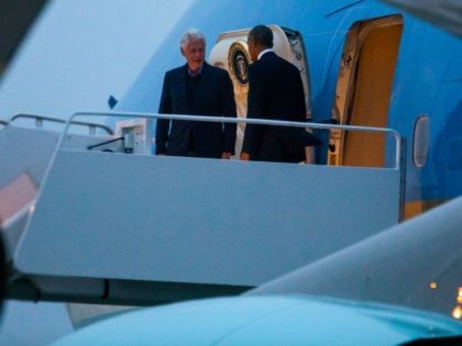 President Barack Obama (R) and former President Bill Clinton (L) walk off Air Force One at Andrews Air Force Base on September 30, 2016 in Joint Base Andrews, Maryland.
